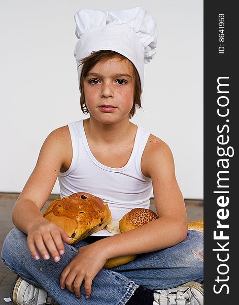 Young baker boy with bread and sandwich. Young baker boy with bread and sandwich