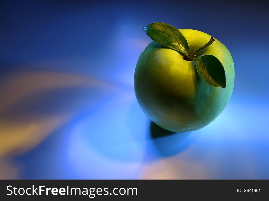 Close up of green apple on blue background