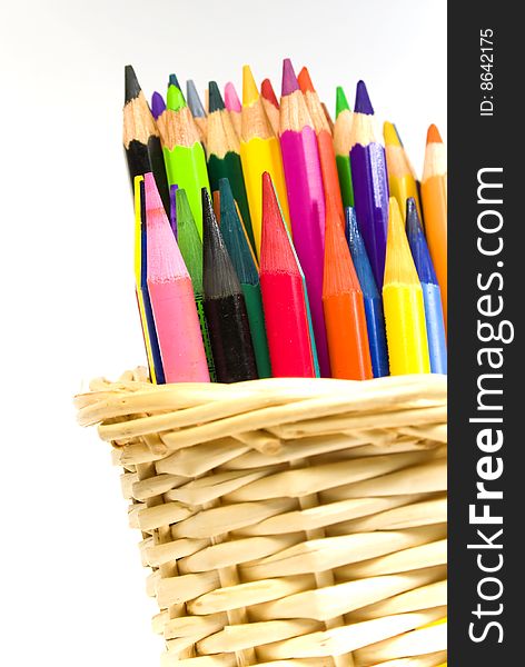 Some color wooden pencils in a bast basket