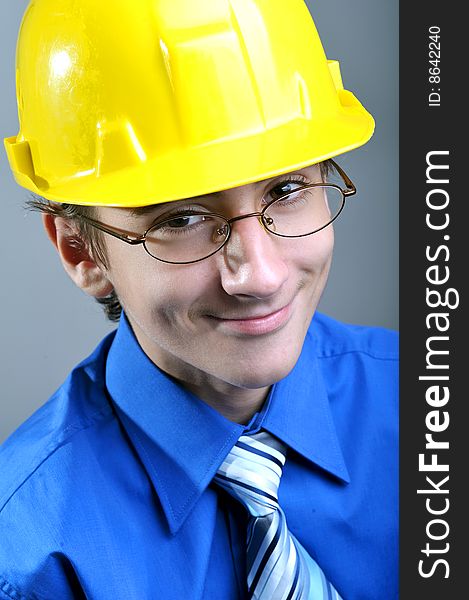 Young engineer wearing hard hat and glasses, close up