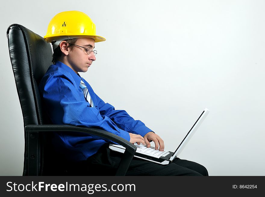 Engineer sitting on office chair and using laptop, isolated on white. Engineer sitting on office chair and using laptop, isolated on white