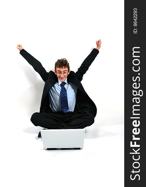 Businessman with laptop cheering with arms up. Businessman with laptop cheering with arms up