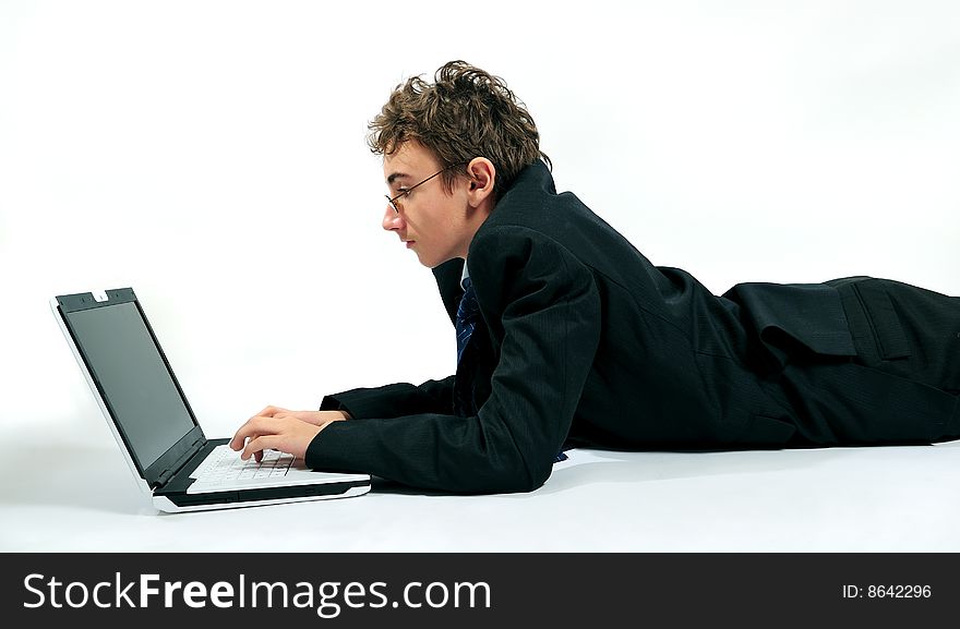 Young businessman using laptop in unusual position