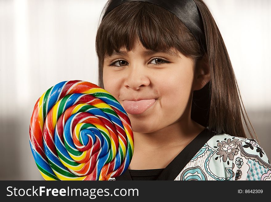 Cute young Hispanic girl with a lollipop. Cute young Hispanic girl with a lollipop