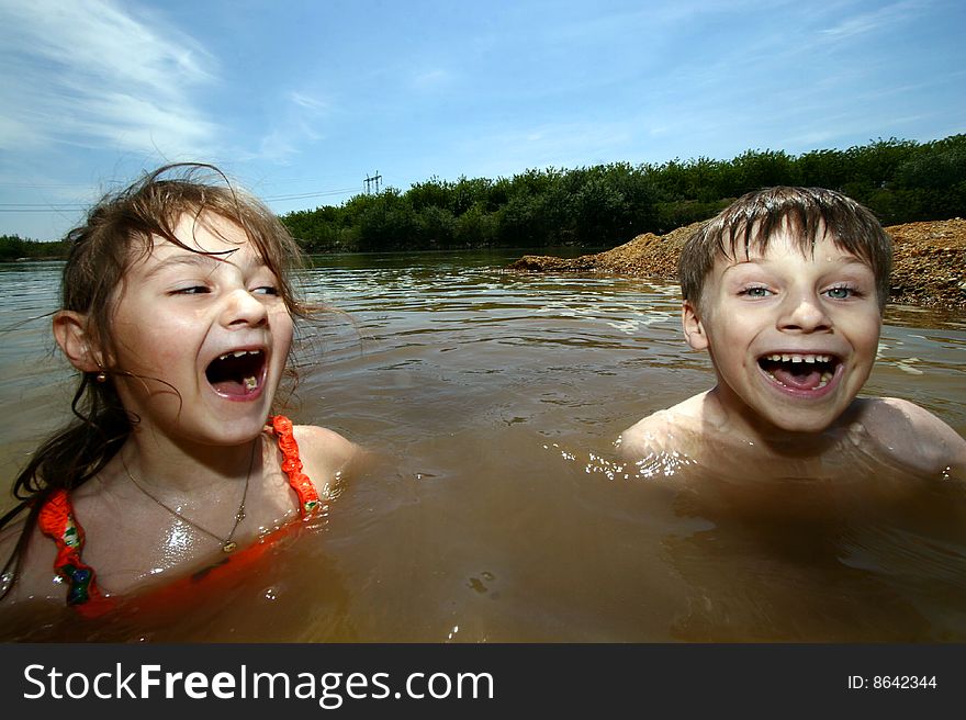 A girl and a boy having fun in a river. A girl and a boy having fun in a river