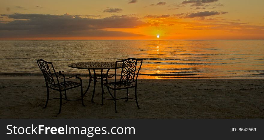 Sunset table for two on the beach