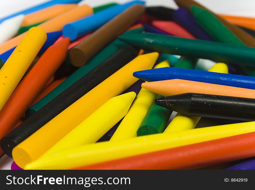 Many wax pencils close up on white