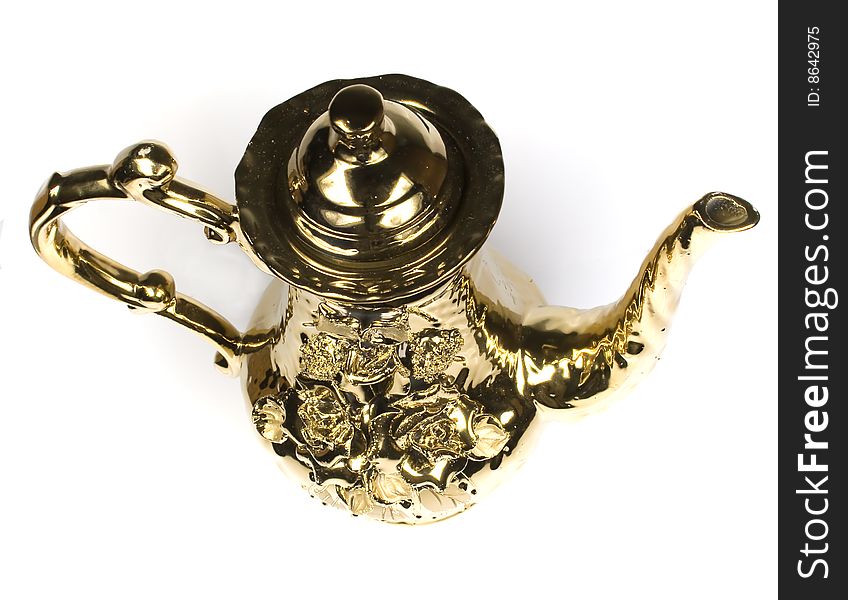 Beautiful gold coffee pot with an ornament on a white background