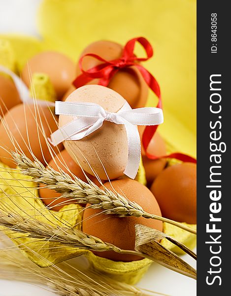 Eggs with red and white baw and wheat, easter concept. Eggs with red and white baw and wheat, easter concept