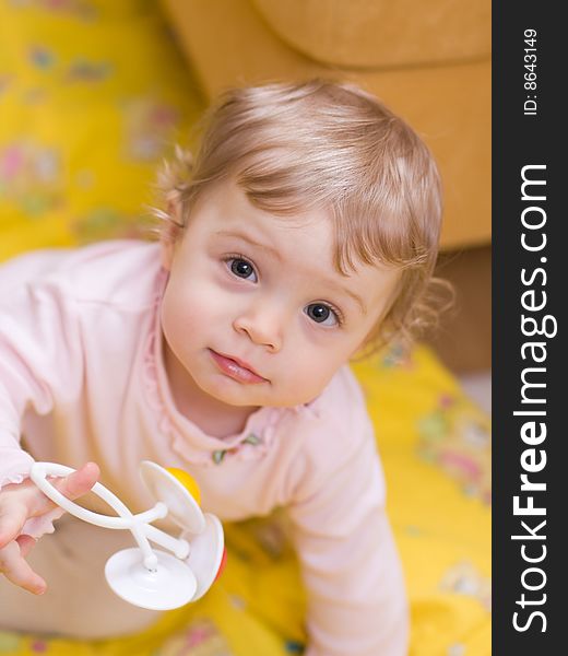 Little girl playing with rattle - shallow DOF