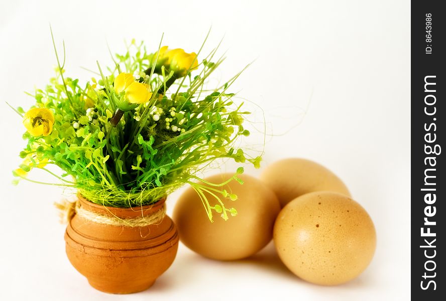 Easter concept - eggs and ceramic vase with flowers. Easter concept - eggs and ceramic vase with flowers