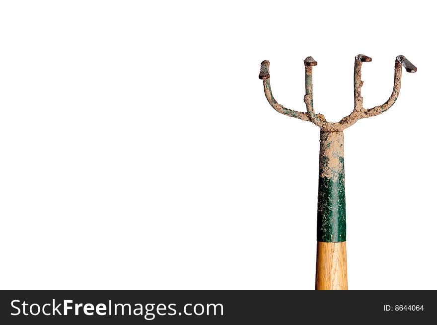 A horizontal view of a wood and metal garden hoe covered with dirt on white