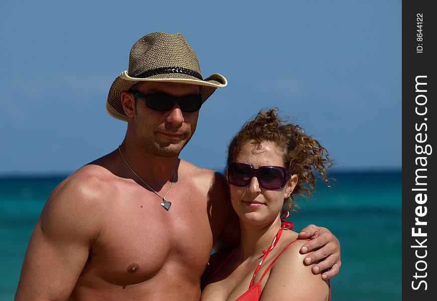 Young couple hanging out on the beach looking buff and in good health a handsome lad and pretty gall. Young couple hanging out on the beach looking buff and in good health a handsome lad and pretty gall.