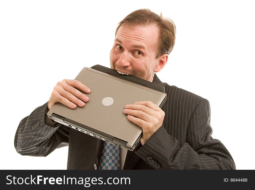 Playful businessman bite off laptop