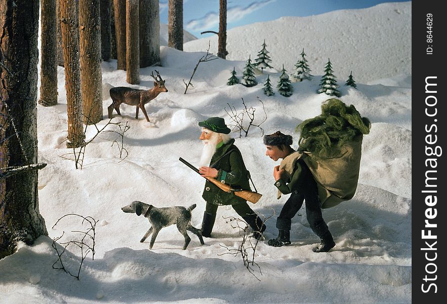 A gamekeeper and his son going to feed animals in the winter. A gamekeeper and his son going to feed animals in the winter