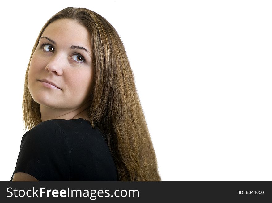 Beautiful young brunette woman looking over her shoulder into copy space. Beautiful young brunette woman looking over her shoulder into copy space.