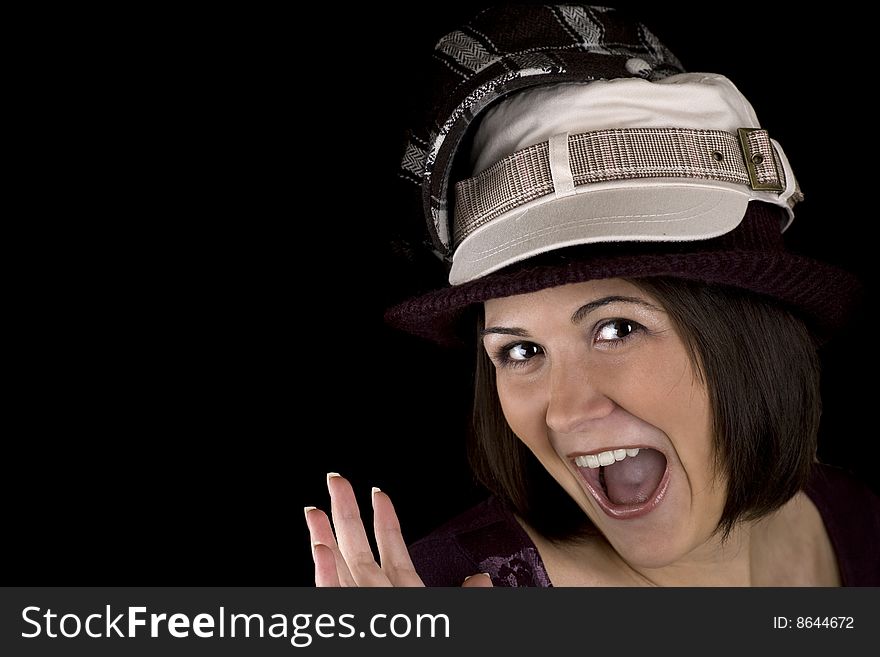 Cute young woman wearing too many hats. Cute young woman wearing too many hats.
