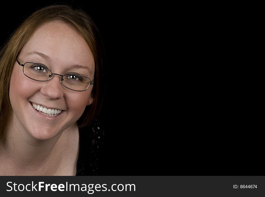 Middle aged woman smiling. Isolated on black, copy-space.
