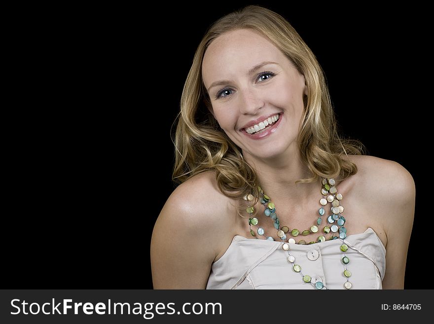 Stunning blonde woman smiling. Isolated on a black background. Stunning blonde woman smiling. Isolated on a black background.
