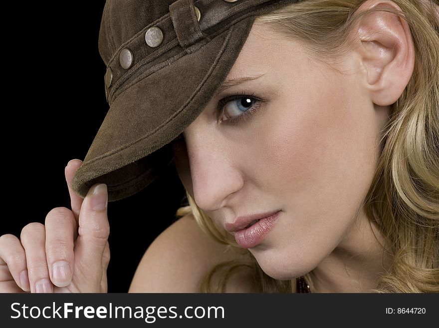 Beautiful female model wearing a hat, blonde hair, blue eyes.