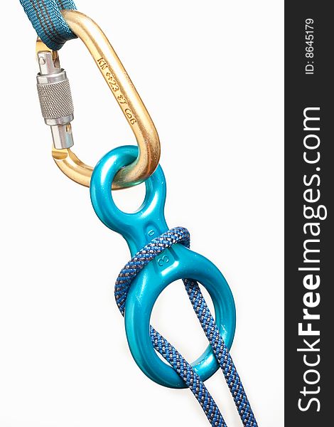 Rock climbing carabiner and decender with rope isolated on white