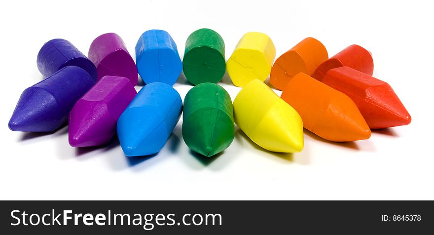 Seven colors wax crayons on white background