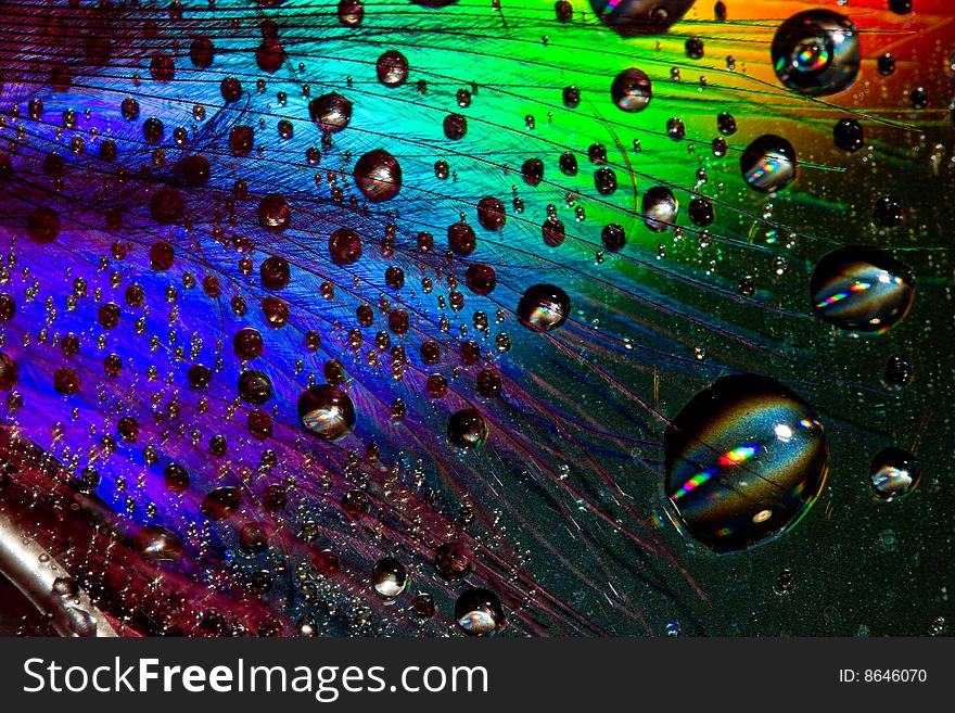 Multi-coloured drops on an iridescent surface. Multi-coloured drops on an iridescent surface