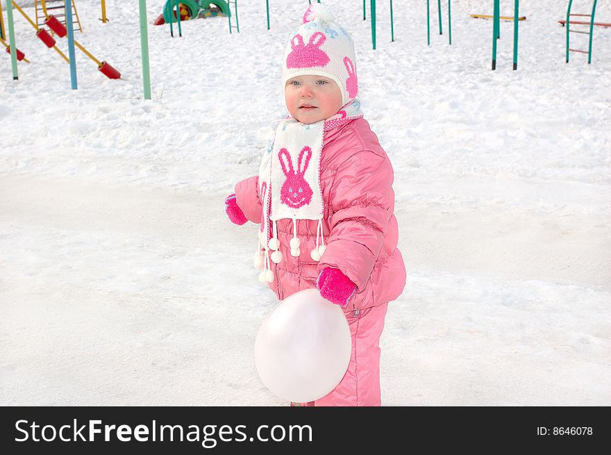 Little Girl On Winter Playground.