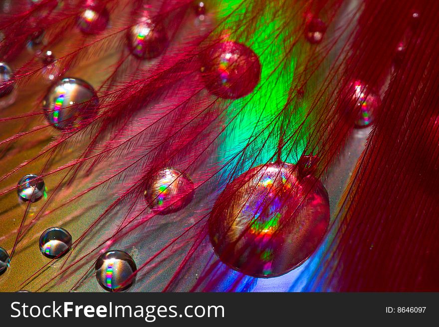 Multi-coloured drops on an iridescent surface. Multi-coloured drops on an iridescent surface