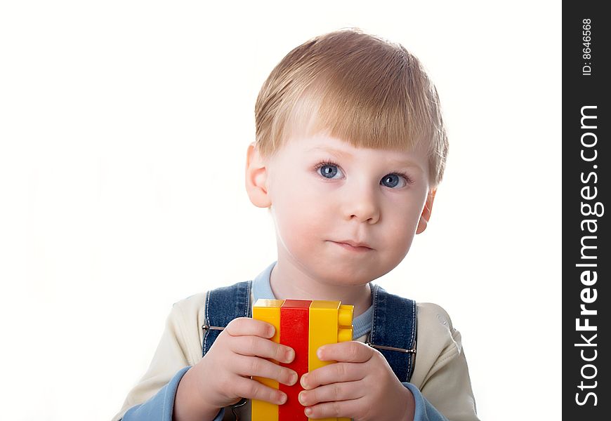 The child the boy plays cubes on a white background