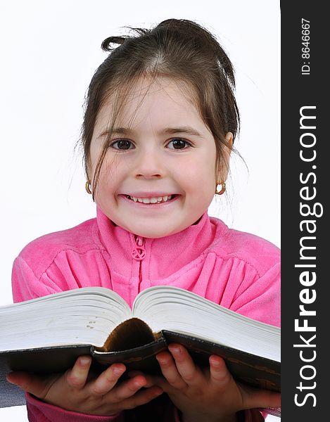 Young schoolgirl in the classroom with a book. Young schoolgirl in the classroom with a book