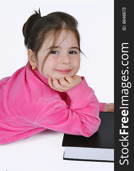 Young schoolgirl in the classroom with a book. Young schoolgirl in the classroom with a book