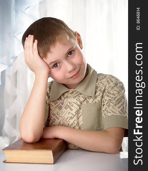 The boy with books on the white background