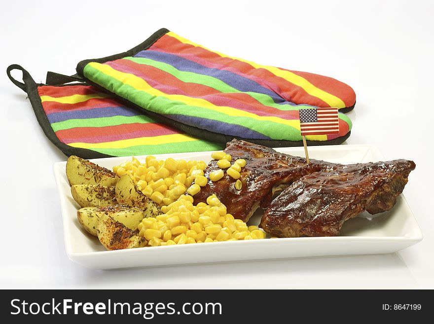 Grilled spare ribs with potatoes and corn. Grilled spare ribs with potatoes and corn