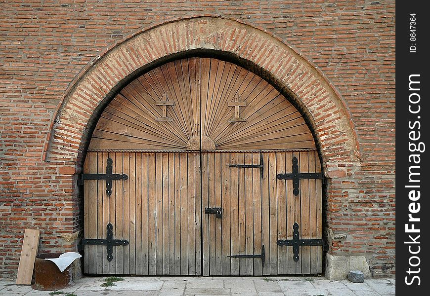 Wooden door with ornamental crosses.