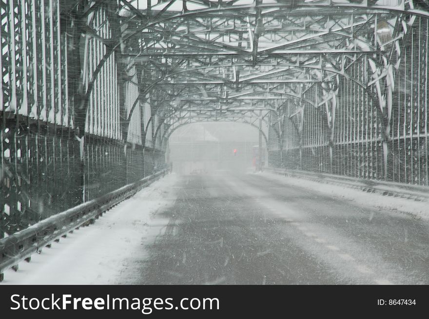 Snowstorm on an old iron bridge