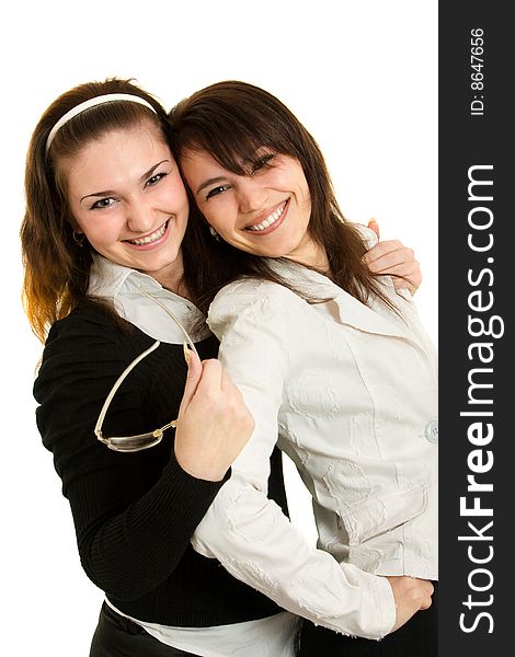 Two young businesswomen look and smile. Two young businesswomen look and smile