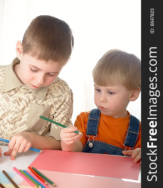 The two child  boy draw  on a white background. The two child  boy draw  on a white background