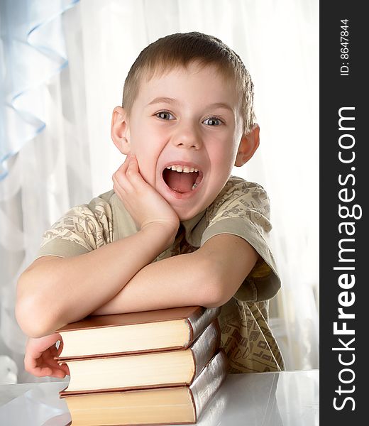 The boy with books on the white background