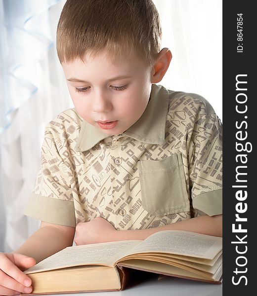 The boy with books on the white background