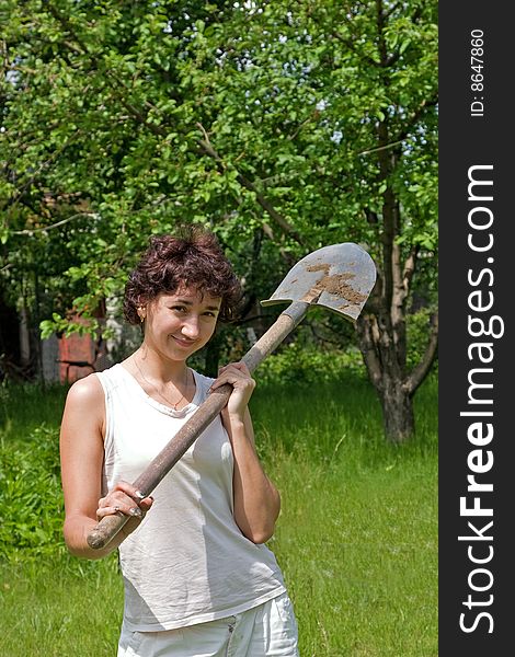 Young girl on lawn with spade. Young girl on lawn with spade