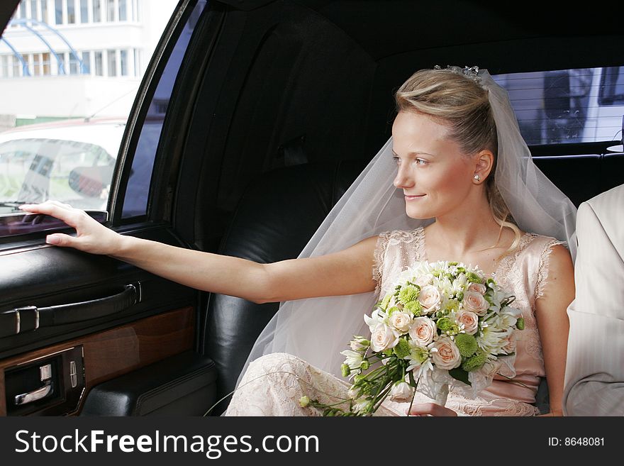 Portrait of the bride sitting in the car