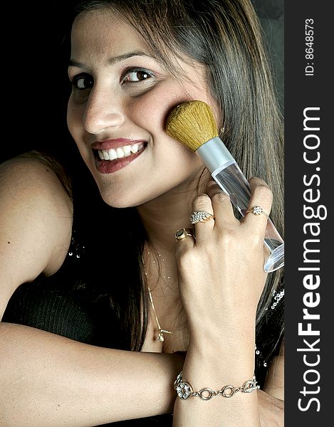 Girl holding a makeup brush. Girl holding a makeup brush