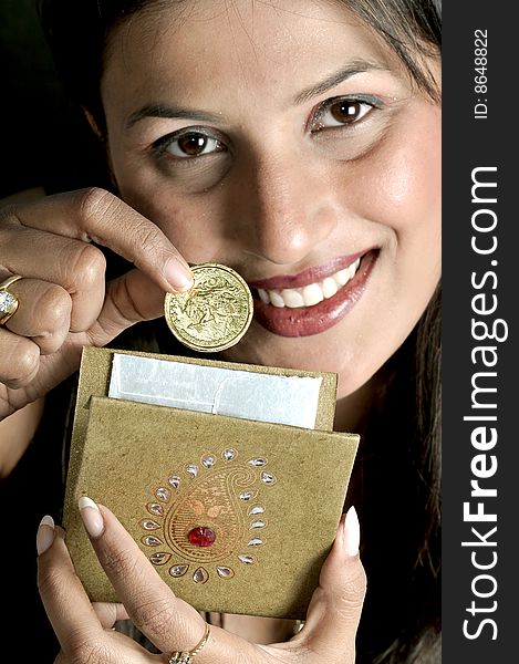 Girl putting coin in an envelope. Girl putting coin in an envelope