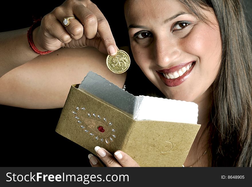 Girl putting coin in an envelope. Girl putting coin in an envelope
