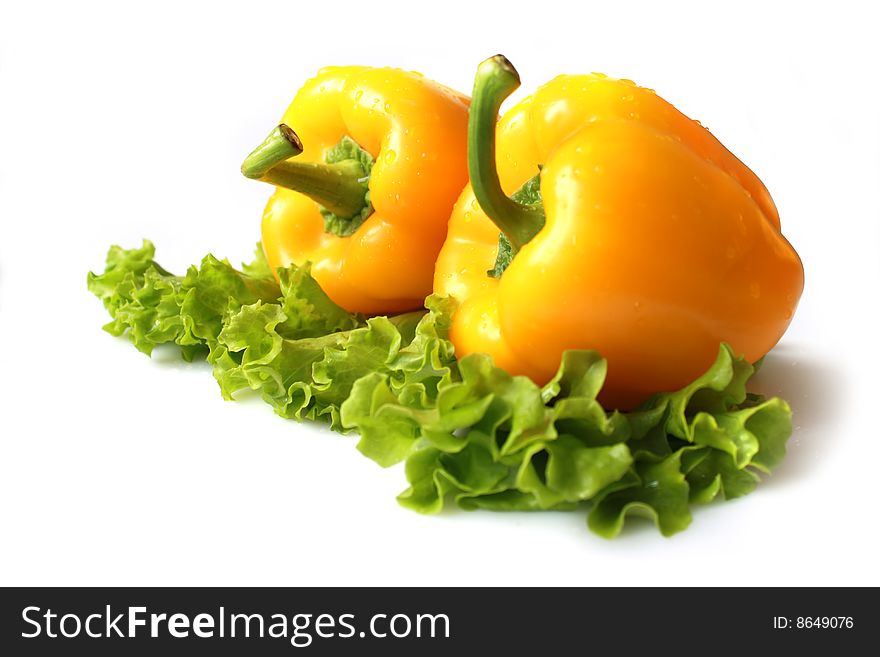 Yellow sweet pepper with lettuce isolated on white background