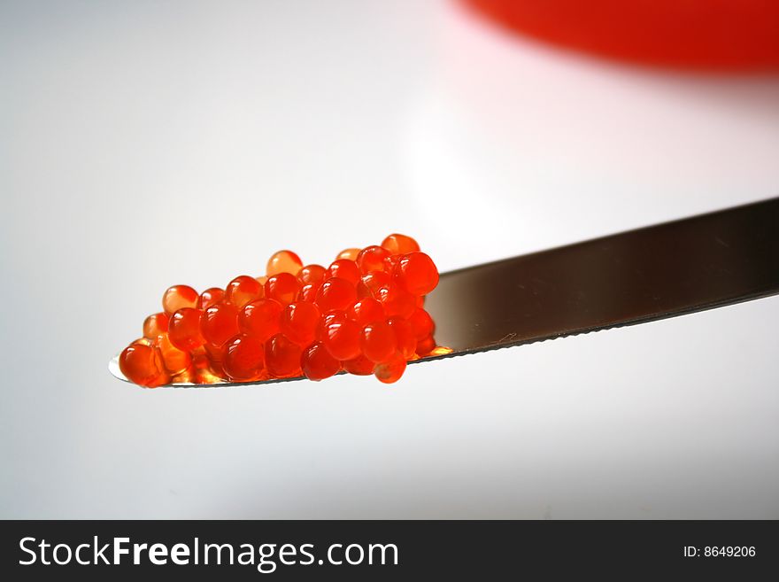 Delicious salmon red caviar and a knife