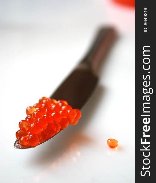 Delicious salmon red caviar and a knife