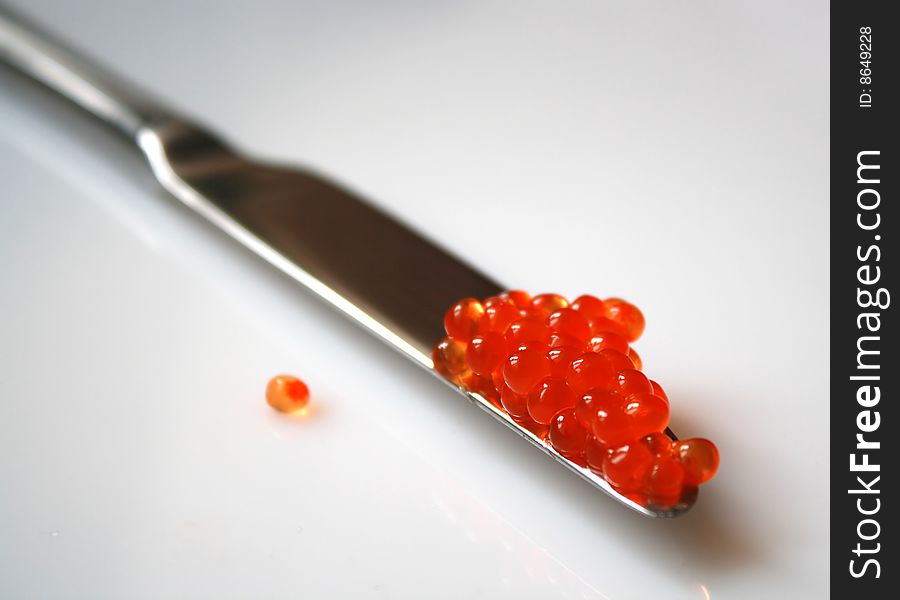 Delicious salmon red caviar and a knife