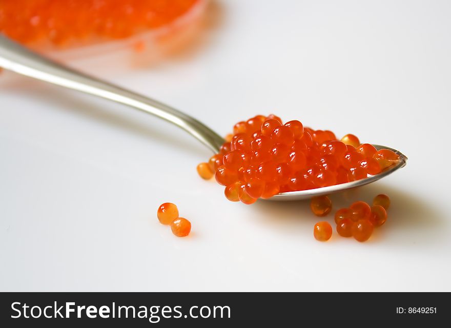 Delicious salmon red caviar and a spoon